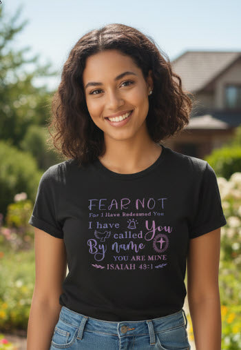 Woman wearing a black t-shirt with a motivational quote outdoors