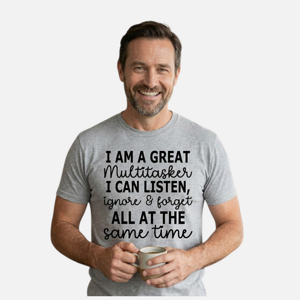 Man wearing a gray t-shirt with humorous text design, holding a mug.