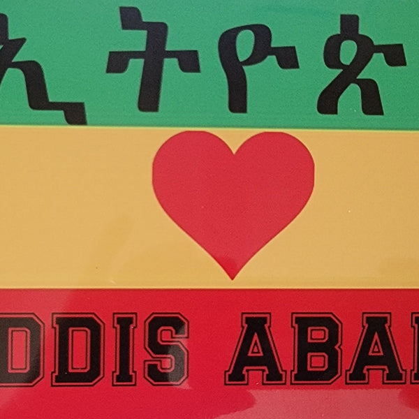 License plate with 'ADDIS ABABA' text and heart symbol on a colorful background