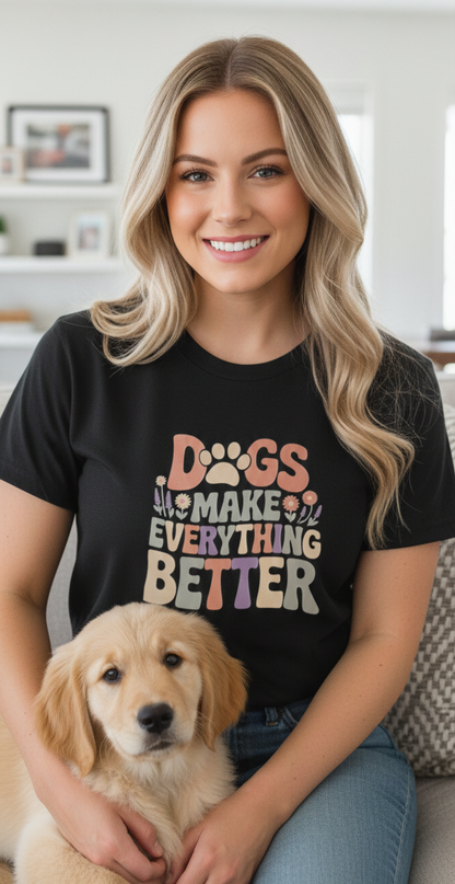 Woman wearing a black t-shirt with a dog-themed design, sitting with a golden puppy.