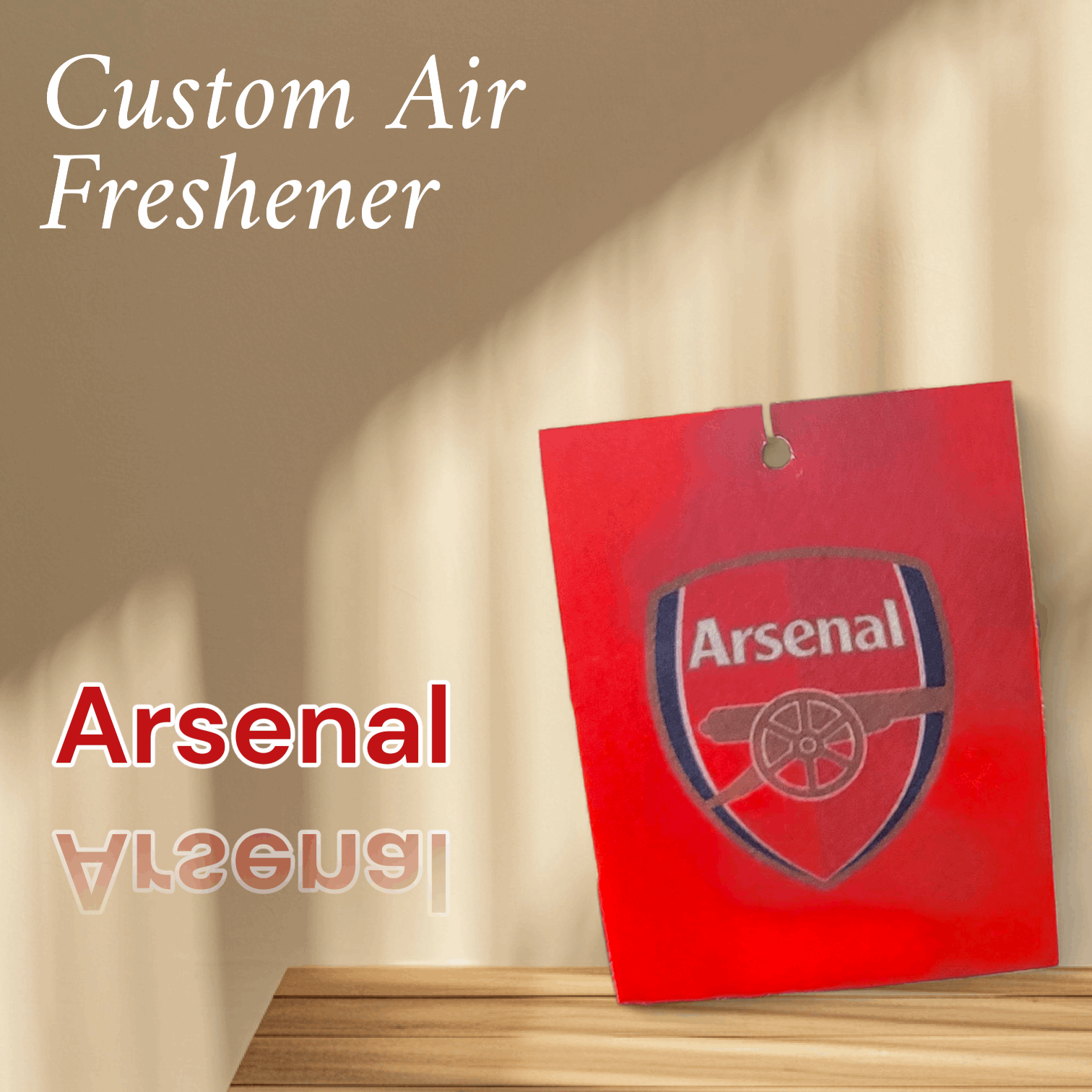 Arsenal air freshener with logo on a wooden surface