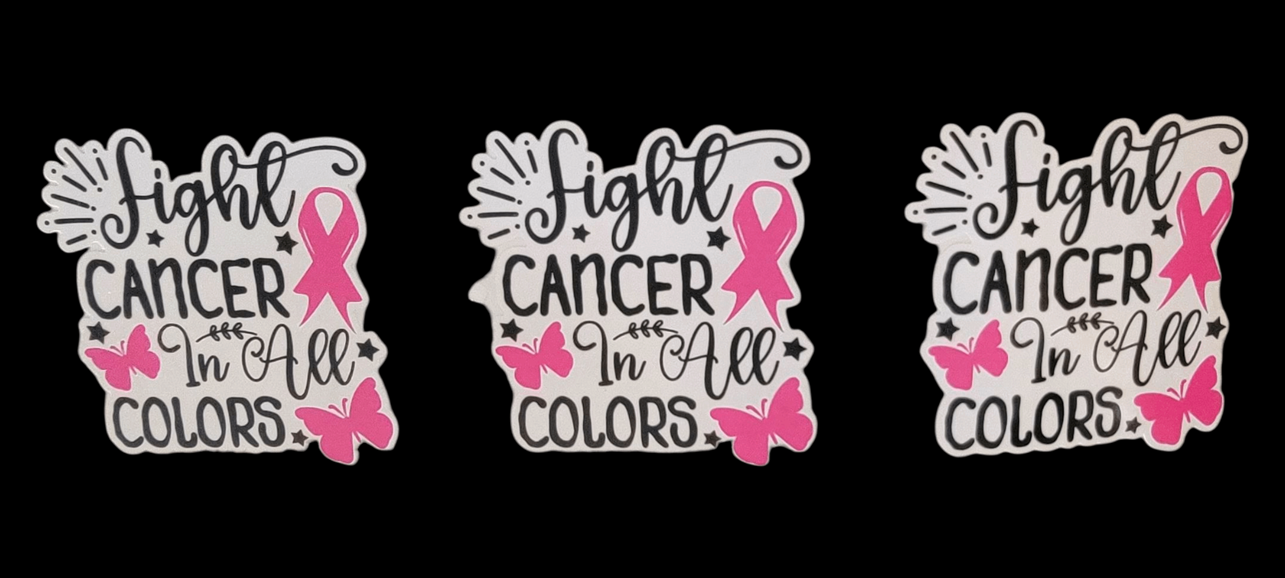 Three decorative stickers with pink ribbons and text on a black background
