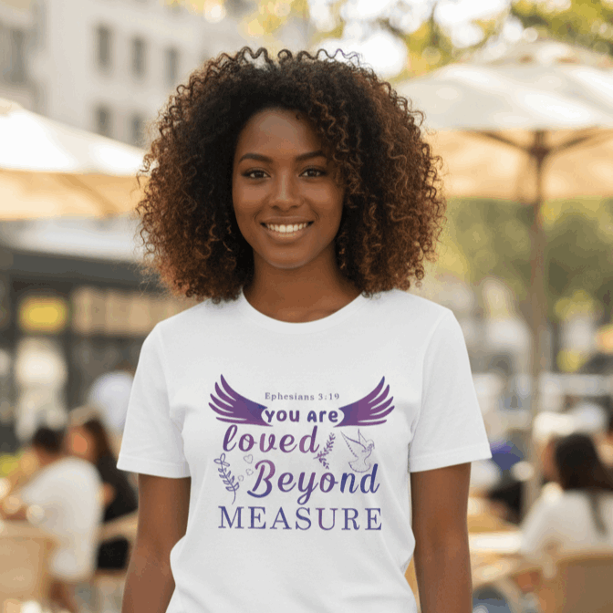 Woman wearing a white t-shirt with a motivational quote outdoors.