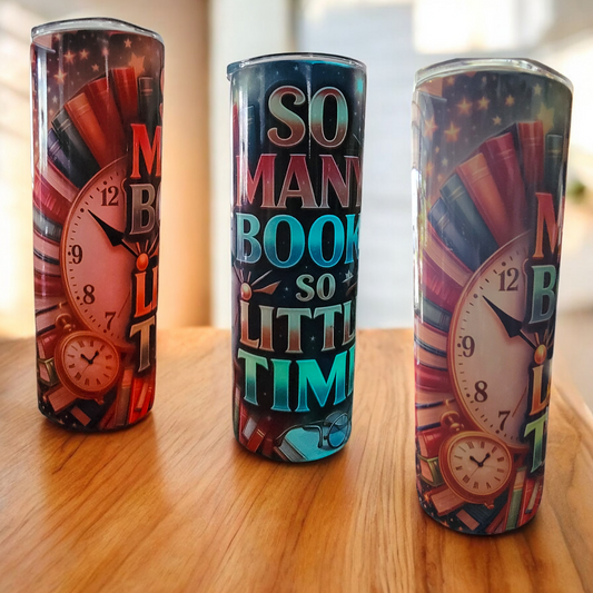 Three colorful tumblers with clock designs and text on a wooden surface.
