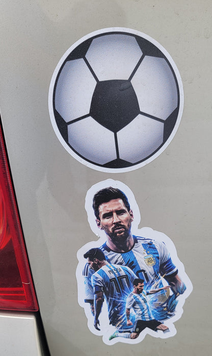 Two stickers on a car: a soccer ball and a person in a blue outfit.